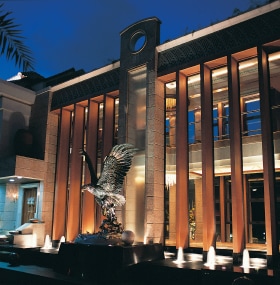 Facade of building lit up at night.